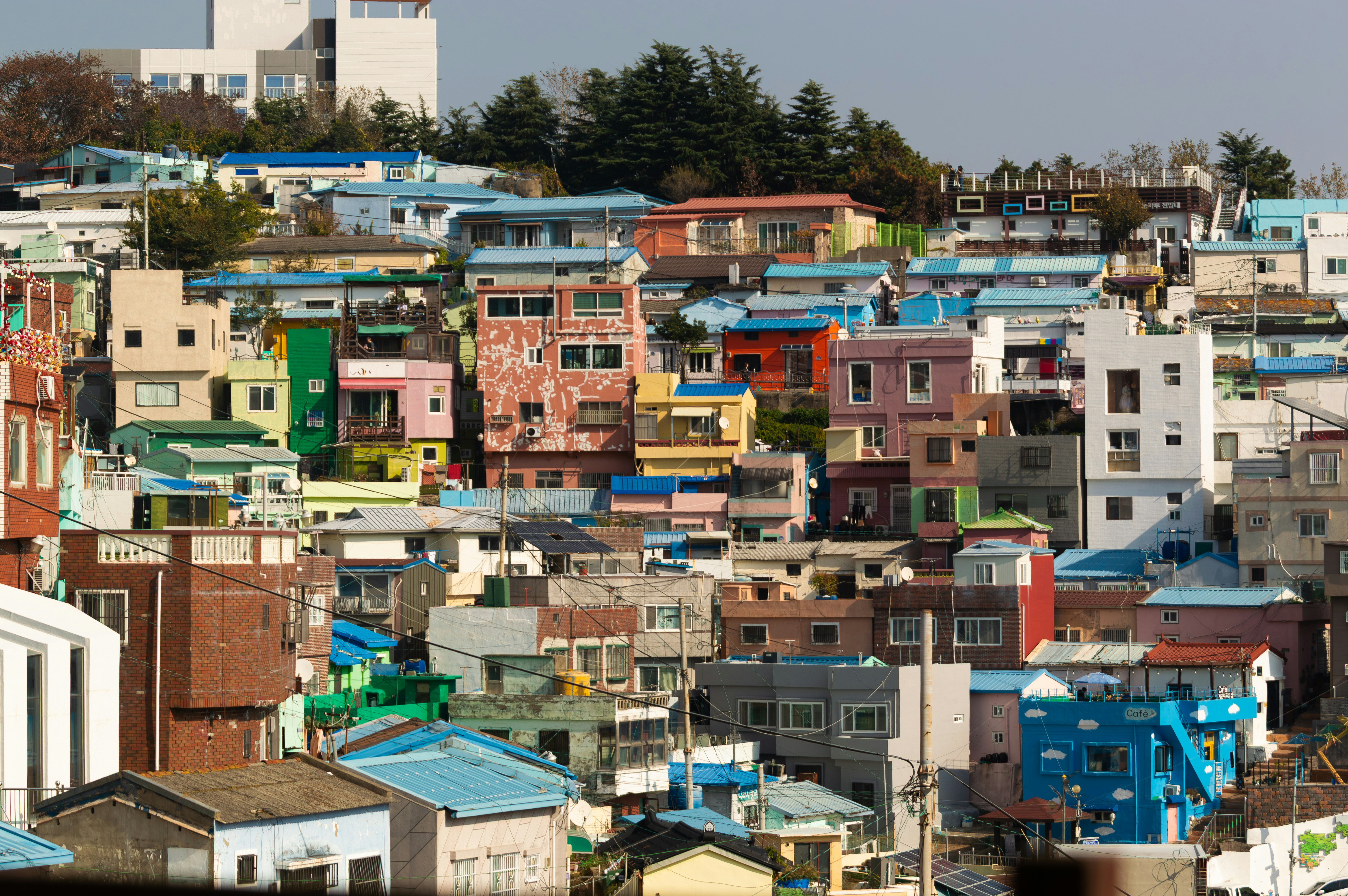 Colorful houses clustered on a hillside under a clear sky